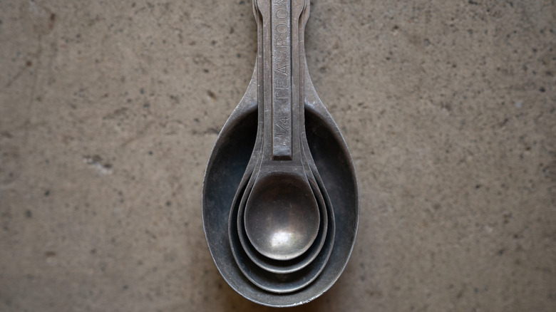 Metal measuring spoons resting on top of one another