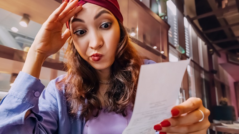 Woman looking at bill